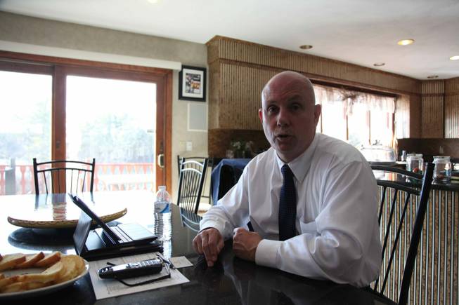 Larry Harrington, chairman of Foxborough's board of selectmen, sits at his kitchen table and explains why he thinks the Kraft-Wynn casino proposal deserves to be heard out by the town residents and why the tax revenue it would bring would be a boost to the town.